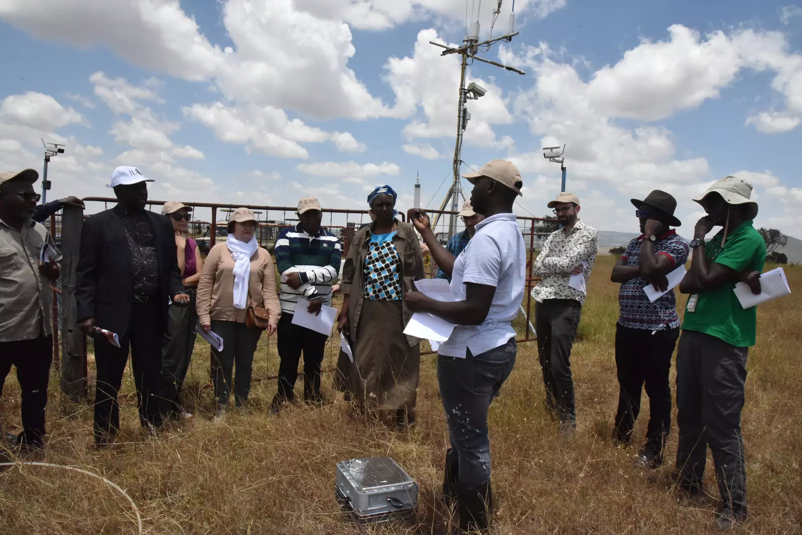 Field technician Nelson Kipchirchir explains to visitors how the Eddy tower measures soil temperature, moisture and other environmental factors in rangeland systems
